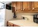 Kitchen countertop with wooden cabinets, refrigerator, and a coffee maker, creating a functional cooking space at 167 Holly Harbor Trl # 169/170, Mount Gilead, NC 27306