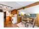 Open kitchen and dining area features wood-paneled walls, white appliances and dining table at 167 Holly Harbor Trl # 169/170, Mount Gilead, NC 27306