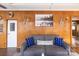 Charming living room with wood paneling, a gray sofa with anchor pillows, and nautical decor at 167 Holly Harbor Trl # 169/170, Mount Gilead, NC 27306