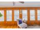 Bright living room with wood floors, large windows, and a comfortable chair, offering serene views at 167 Holly Harbor Trl # 169/170, Mount Gilead, NC 27306