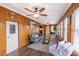Cozy living room features wood walls, plush seating, and multiple windows for natural light at 167 Holly Harbor Trl # 169/170, Mount Gilead, NC 27306