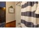 Bathroom shower with a striped curtain, complemented by a 'Relax Soak Unwind' sign, creating a tranquil ambiance at 167 Holly Harbor Trl # 169/170, Mount Gilead, NC 27306