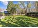 Expansive backyard with lush green grass and mature trees is perfect for outdoor activities at 2016 Monaghan Ct, Matthews, NC 28105