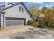 Exterior shot of home featuring an attached garage and basketball hoop in driveway at 2016 Monaghan Ct, Matthews, NC 28105