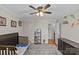 Neutral bedroom features hardwood floors, a ceiling fan, and a crib with storage at 2016 Monaghan Ct, Matthews, NC 28105