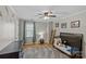 Bright bedroom features hardwood floors, a ceiling fan, and a crib with stuffed animals at 2016 Monaghan Ct, Matthews, NC 28105