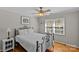 Inviting bedroom with warm hardwood floors and natural light streaming through the window at 2016 Monaghan Ct, Matthews, NC 28105