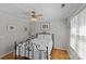 Bright bedroom features hardwood floors, natural light, and a bed with a white comforter at 2016 Monaghan Ct, Matthews, NC 28105