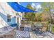 Relaxing deck area with shade, comfortable seating, dining table, and outdoor decor at 2016 Monaghan Ct, Matthews, NC 28105