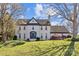 Stunning white brick home featuring a well-manicured lawn and inviting landscaping, offering timeless charm at 2016 Monaghan Ct, Matthews, NC 28105