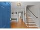 Welcoming foyer with hardwood floors, staircase, and stylish lighting, showcasing a grand entrance at 2016 Monaghan Ct, Matthews, NC 28105