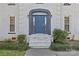 Close-up view of the front door with its elegant archway, sidelights, and complementary landscaping at 2016 Monaghan Ct, Matthews, NC 28105