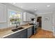 Bright kitchen featuring granite counters, white cabinets with gold hardware, and stainless appliances at 2016 Monaghan Ct, Matthews, NC 28105
