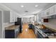 Spacious eat-in kitchen features granite counters, white cabinets, dark island, and stainless appliances at 2016 Monaghan Ct, Matthews, NC 28105