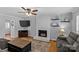 Comfortable living room featuring a painted white fireplace, neutral walls, and a ceiling fan at 2016 Monaghan Ct, Matthews, NC 28105