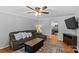 Cozy living room with ceiling fan, neutral walls, and views to the kitchen at 2016 Monaghan Ct, Matthews, NC 28105