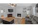 Comfortable living room featuring a painted white fireplace, neutral walls, and a ceiling fan at 2016 Monaghan Ct, Matthews, NC 28105