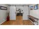 Inviting office entrance featuring stylish barn doors, hardwood floors, and a glimpse of the workspace at 2016 Monaghan Ct, Matthews, NC 28105