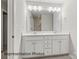 Bright bathroom featuring double sink vanity, white cabinets, large mirror, and modern fixtures at 2019 Mcdonald Dr, Charlotte, NC 28216