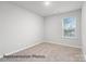 Neutral bedroom featuring a window that provides lots of natural light and carpeted floors at 2019 Mcdonald Dr, Charlotte, NC 28216