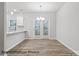 Bright dining room with a stylish light fixture and door to the backyard at 2019 Mcdonald Dr, Charlotte, NC 28216