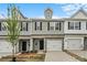 Townhome featuring attached garage, multiple windows, and complementary exterior colors at 2019 Mcdonald Dr, Charlotte, NC 28216