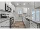 Modern kitchen features stainless steel appliances and granite countertops at 2019 Mcdonald Dr, Charlotte, NC 28216