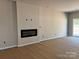Modern living room with sleek fireplace and sliding glass door access to backyard at 2019 Mcdonald Dr, Charlotte, NC 28216