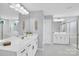 Bathroom with double sinks, white cabinets, white counters and large mirrors at 2019 Taylorcrest Dr, Fort Mill, SC 29715