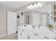 Bright bathroom features white cabinets, double sinks and large mirror with a connecting door to the toilet and shower area at 2019 Taylorcrest Dr, Fort Mill, SC 29715