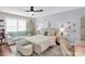 Stylish bedroom features a comfy bed, white couch, ceiling fan and elegant decor for relaxation and comfort at 2019 Taylorcrest Dr, Fort Mill, SC 29715