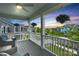 Inviting front porch with gray floors, white railings and posts, ceiling fan, and neighborhood views at sunset at 2019 Taylorcrest Dr, Fort Mill, SC 29715