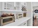 Kitchen nook with white cabinets, wine wrack, stainless toaster oven and white countertops at 2019 Taylorcrest Dr, Fort Mill, SC 29715