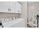 Functional laundry room featuring a washer, dryer, overhead cabinets, and laundry supplies for efficient chores at 2019 Taylorcrest Dr, Fort Mill, SC 29715