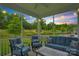Relax on the screened porch featuring comfortable seating and views of the manicured backyard at sunset at 2019 Taylorcrest Dr, Fort Mill, SC 29715