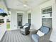Charming porch featuring dual wicker chairs, neutral cushions, privacy windows, and a cooling ceiling fan at 2019 Taylorcrest Dr, Fort Mill, SC 29715