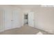 Cozy bedroom with neutral carpet and paint; closet doors and entry to bathroom at 2052 Harlequin Dr, Indian Trail, NC 28079