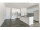 Modern kitchen with white cabinets, gray backsplash and center island with stone countertops at 2052 Harlequin Dr, Indian Trail, NC 28079