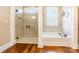 Bathroom featuring a glass enclosed shower and a soaking tub with a window at 2236 Tuckaway Rd, Rock Hill, SC 29730