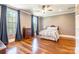 This bedroom features hardwood floors, large windows, and a ceiling fan at 2236 Tuckaway Rd, Rock Hill, SC 29730