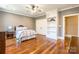 Cozy bedroom with a built-in bookshelf, hardwood floors, and a ceiling fan at 2236 Tuckaway Rd, Rock Hill, SC 29730