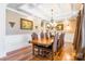 Formal dining room with rich hardwood floors, coffered ceiling, and ornate chandelier at 2236 Tuckaway Rd, Rock Hill, SC 29730