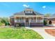 Inviting brick home featuring a classic front porch, complemented by a well-maintained yard at 2236 Tuckaway Rd, Rock Hill, SC 29730