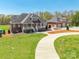 Inviting brick home with a charming front porch and a detached garage, set on a well-manicured lawn at 2236 Tuckaway Rd, Rock Hill, SC 29730