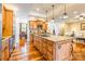 Open kitchen with large island, granite countertops, and wood floors flowing into the dining area at 2236 Tuckaway Rd, Rock Hill, SC 29730