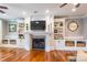 Bright living room featuring wood floors, built-in shelving, fireplace and a flat screen TV at 2236 Tuckaway Rd, Rock Hill, SC 29730