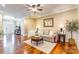 Inviting living room with hardwood floors, decorative mirror, and comfortable seating arrangement at 2236 Tuckaway Rd, Rock Hill, SC 29730