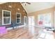 Spacious sunroom featuring brick walls, vaulted ceiling, and beautiful hardwood floors at 2236 Tuckaway Rd, Rock Hill, SC 29730