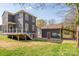 The backyard features a detached garage with a convenient carport and a wooden deck off the main house at 232 Cromer St, Charlotte, NC 28208