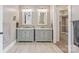 Well-lit bathroom with dual vanities, and a view into the walk-in closet at 232 Cromer St, Charlotte, NC 28208